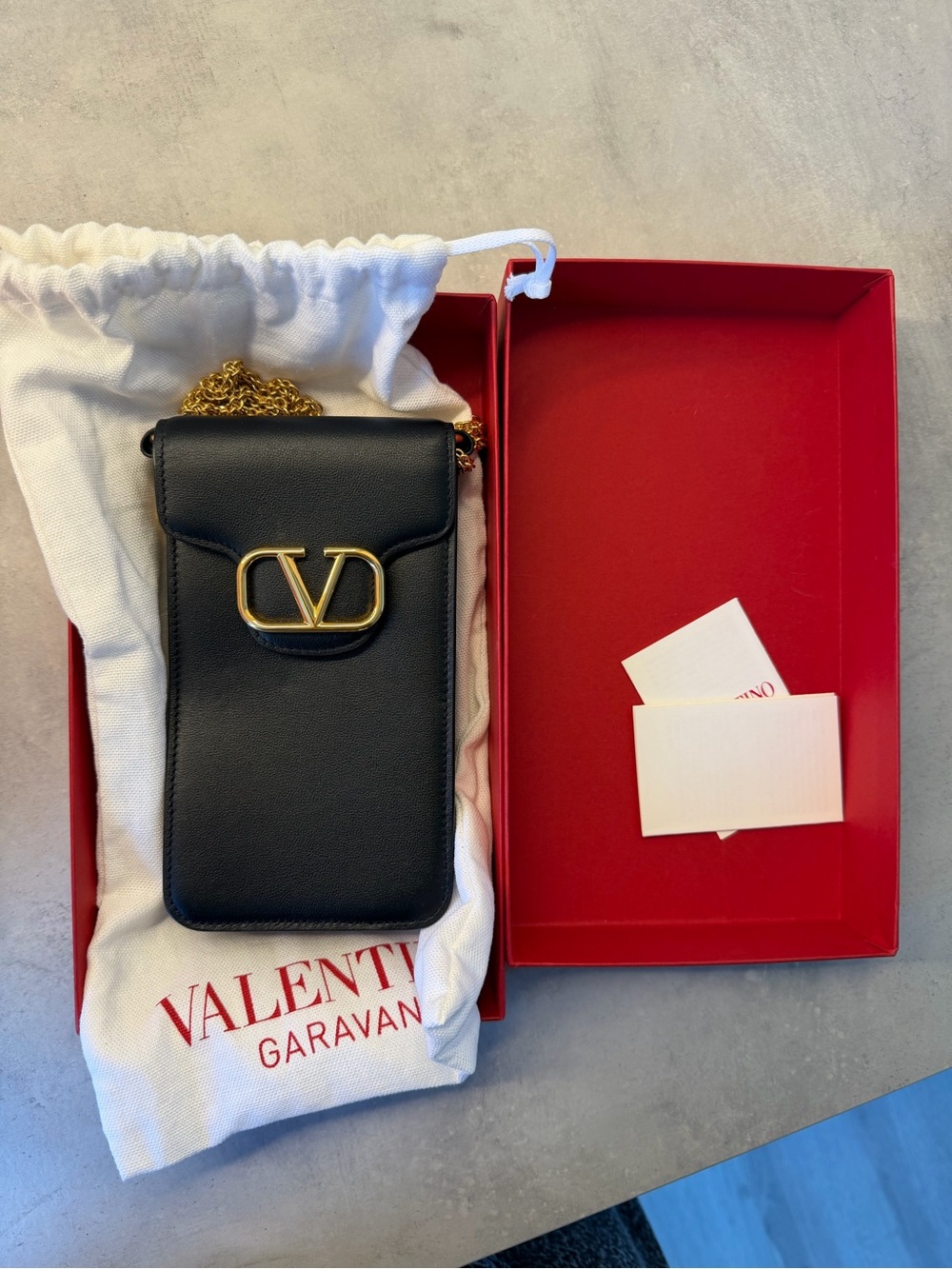 Valentino Garavani Black Leather Phone Pouch with Gold V Logo Chain Strap